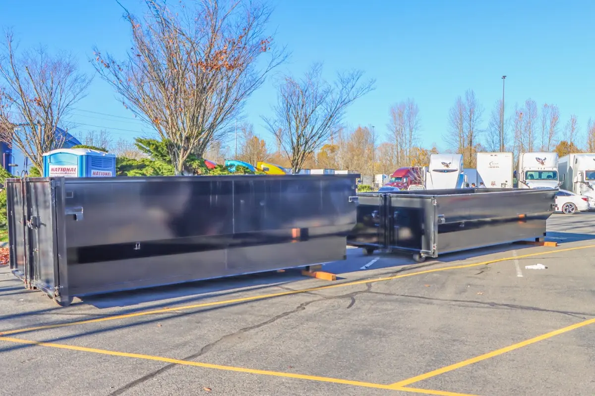 Professional dumpster rental service with roll-off container on residential driveway in Veneta